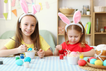 Children paint Easter eggs for the holiday.
