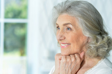 Fototapeta na wymiar Close up portrait of beautiful smiling senior woman