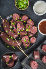 Korean traditional national food. Street home Asian cuisine. Sliced blood sausage soondae or sundae, with rice, noodles, pork meat. With sauces and herbs