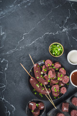 Korean traditional national food. Street home Asian cuisine. Sliced blood sausage soondae or sundae, with rice, noodles, pork meat. With sauces and herbs