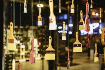 Assortment of paintbrushes hanging on display