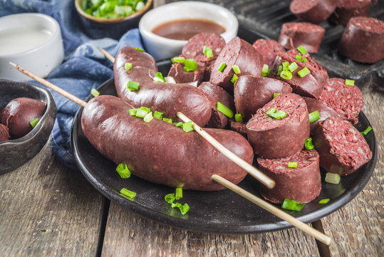 Korean traditional national food. Street home Asian cuisine. Sliced blood sausage soondae or sundae, with rice, noodles, pork meat. With sauces and herbs