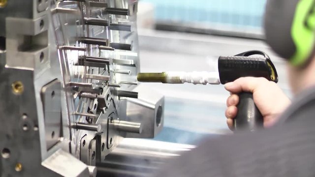 Service / Maintenance of Plastic Injection Mold during Production Freezing the Injection Mold using Dry Nitrogen Freezing Gun in Automotive Factory, Industrial Concept