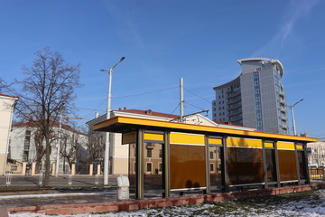 yellow bench at tramway station in city