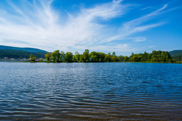 Green island in the middle of the mighty Siberian river