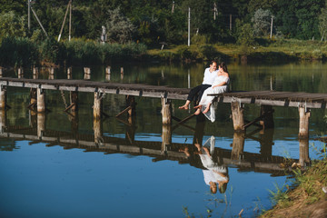 couple sitting on old bridge