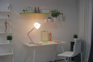 Stylish room interior with comfortable workplace. Design idea