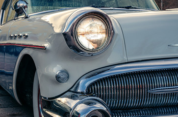 Partial front view of a classic car from the fifties
