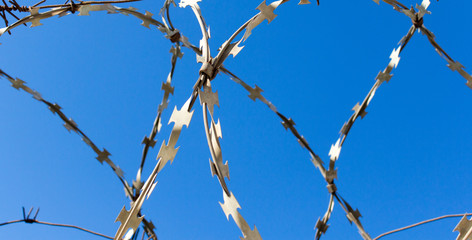 barbed wire against the blue sky