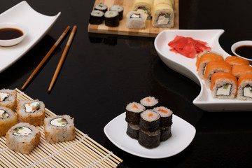 Philadelphia roll sushi with salmon, prawn, avocado, cream cheese. Sushi menu. Japanese food on black background