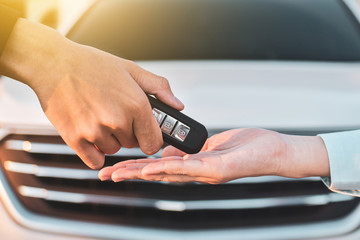 Close up hand holding Key sale car concept,Give and take key car