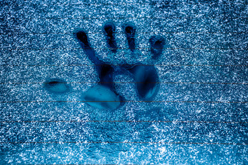 Handprint on the frozen glass of a car. Cold and ice. Concert for design.