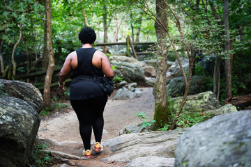 Woman walking up mountain nature trail