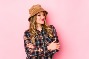 Young caucasian woman wearing a hat isolated who feels confident, crossing arms with determination.
