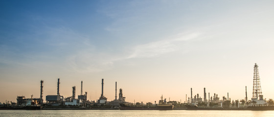 Fototapeta premium Oil refinery or petrochemical industry with ship in thailand. for Logistic Import Export background.