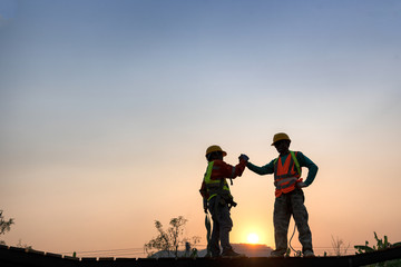 Engineers in green helmet and the best greetings with the warm handshake team Visit the website...