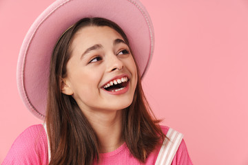 Photo of lovely charming girl in hat laughing and posing at camera
