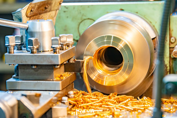 Bronze on a lathe, processing and manufacturing of parts from brass on a CNC machine.