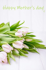 Happy Mother's day greeting card. Inscription, text, words. Pink spring flowers tulips on a white background