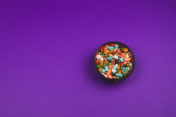 Candy bowl with sweets in the form of colorful stones. colored candies