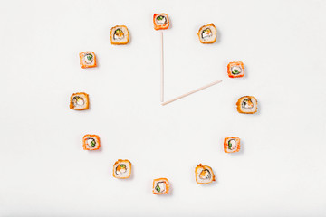 Sushi or rolls time in the form of a wall clock on a white background