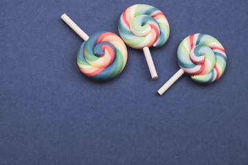 Colorful candies. lollipops isolated on blue background. festive concept. copy space