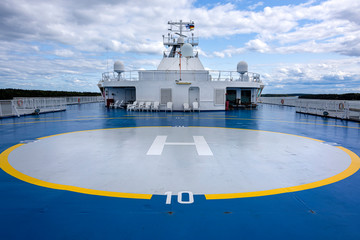 Helicopter landing site helipad helideck of a big ship boat tanker with captain's bridge in the...