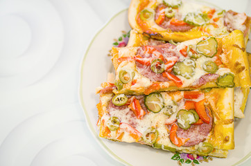 Homemade pizza on a white plate. Pizza made with your own hands. Homemade cake.