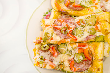 Homemade pizza on a white plate. Pizza made with your own hands. Homemade cake.