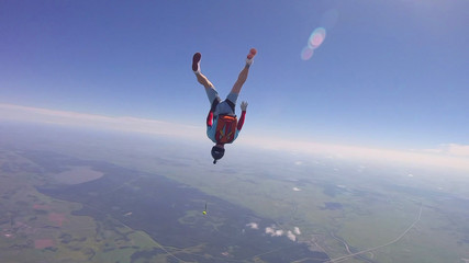 Fototapeta na wymiar Student. Man in professional equipment hovers in the air. Skydiver studies the sky.