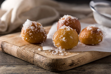Carnival fritters or buñuelos de viento for holy week on wooden table