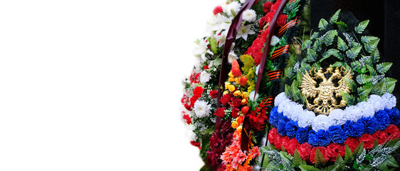 Fototapeta na wymiar mourning wreath of flowers and emblem of Russian Federation on white background. Funeral wreath, colors of Russian flag, two-headed eagle. memory concept. copy space