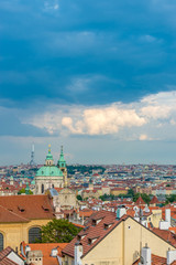 Top view to red roofs and dramatic sky of Prague city Czech republic.