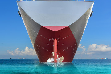 Stern Cargo ship in the sea, Propeller with rudder in export with stern view sailing in the sea and...