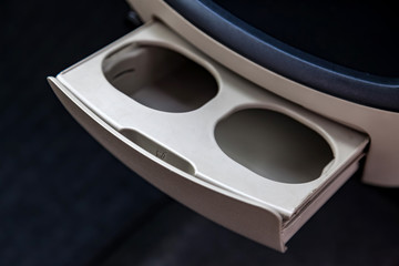 Two retractable cup holders for drinks, tea or coffee on the car panel.
