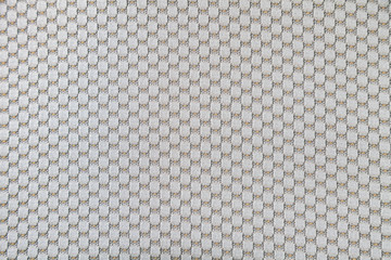 Background from beige textile material with a pattern and threads for clothes or upholstery