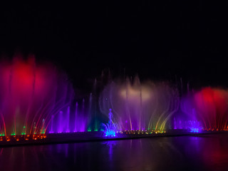 Nha Trang, Vietnam - December 23, 2019: View of the Fountain Show in the Vinpearl Amusement Park by night. - obrazy, fototapety, plakaty