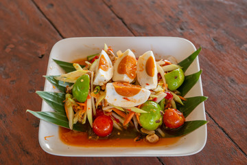 Thai papaya salad on wood table