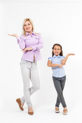 Fototapeta premium a portrait of the mother with her young daughter dancing on a white background