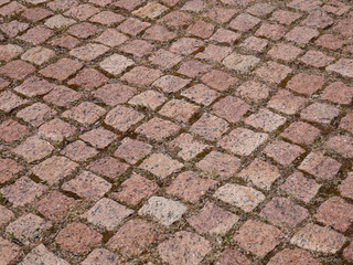 Old paving stones in perspective closeup, background, texture.