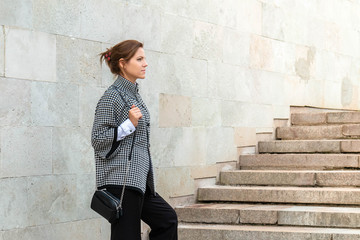 Determined woman standing on stairs. Concept of successful woman