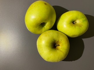 green apples on gray background
