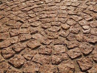 Old paving stones in perspective closeup, background, texture.