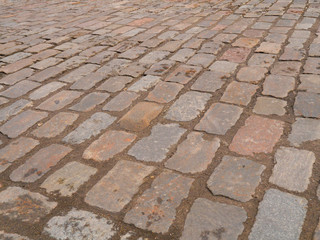 Old paving stones in perspective closeup, background, texture.