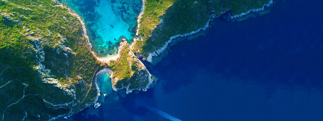 Aerial drone ultra wide photo of famous double paradise azure beach of Porto Timoni in Northern...