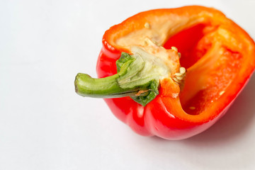 red bulgarian pepper in a longitudinal cut on a white background close-up with a blurry background