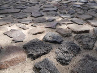 Old paving stones in perspective closeup, background, texture.