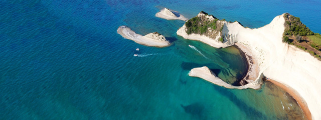 Aerial drone ultra wide photo of iconic white rock steep cliff volcanic bay of Cape Drastis and Peroulades area with tropical deep turquoise clear sea, Corfu island, Ionian, Greece