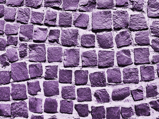 Old paving stones closeup. Purple background.