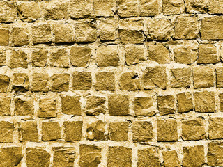 Old paving stones closeup. Background in golden color.